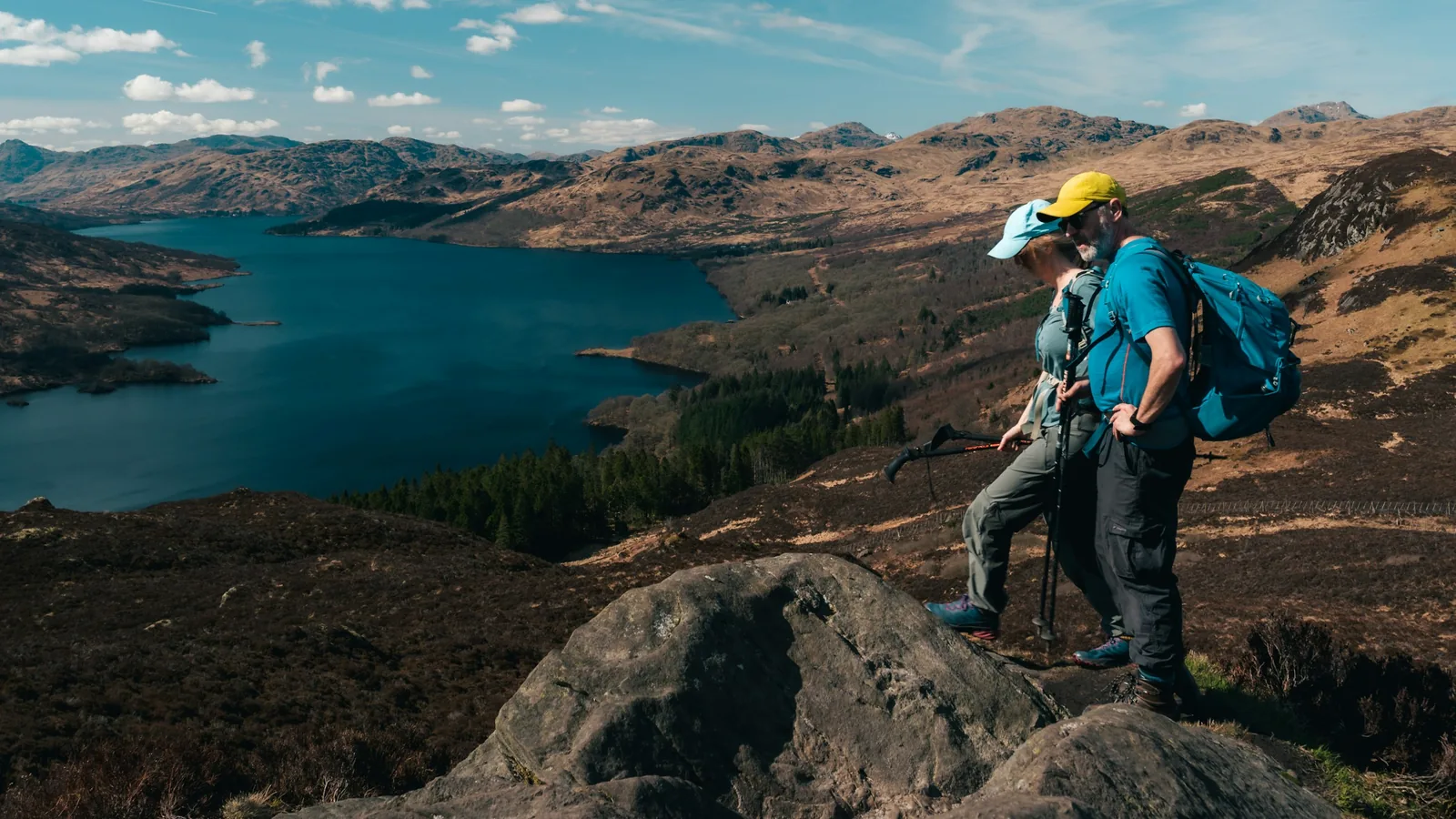 Two backpacked walkers above a loch on Ben A’an, Scotland